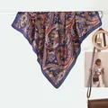 Navy and orange paisley silk-like scarf draped elegantly on a display rod for women - Navy Paisley