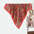 Elegant red paisley silk scarf with satin finish displayed in a lifestyle setting - Red Paisley