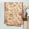 Close-up of beige velvet scarf with vintage brown peony floral print and fine hemmed edges - Khaki