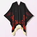 Detailed view of ethnic knit poncho featuring black fabric with red jacquard and fringe - Pullover Colorful Bird Black Red