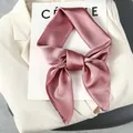 Detail of pink silk square scarf tied in a bow on a blazer, elegant texture and finish - One Size / Lotus root pink