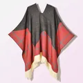 Detail of knit cape featuring red plaid pattern with ivory tassel fringe edges - Pullover Five Star Plaid Black Red