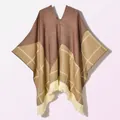 Detail of vintage knit poncho featuring brown patchwork, plaid patterns and fringe tassel hem - Pullover Five Star Plaid Coffee