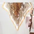 Baroque style silk scarf with vintage Roman patterns and gold border shown on a display stand - Castle Coffee White