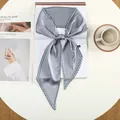 Detailopname van grijsblauwe satijnen sjaal met houndstooth-rand op tijdschrift - Grijs Houndstooth Rand (32)