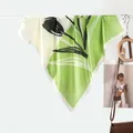 Green and beige silk scarf with abstract tulip print hanging on a white rack display - 70x70cm / Tulip Grass Green