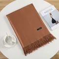 Caramel cashmere scarf with tassels styled on a white table with a coffee cup - Light Coffee