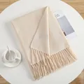 Detailed close-up of cream knit scarf texture with soft fringe edges and cozy material - Cream Rice