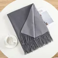 Detailed view of grey cashmere-feel knit scarf featuring fringe ends and dual-tone design - Medium Gray