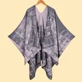 Detail view of the fine knit texture and jacquard pattern on a warm grey and lilac poncho shawl - Dusty Pink