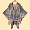 Detail of soft knitted double-sided jacquard poncho shawl with vintage geometric patterns - Gray