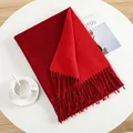 Elegant solid red cashmere-like scarf with fringe detail on a stylish desk setup - Christmas Red