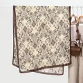 Close-up of lightweight paisley pattern shawl with brown borders on a white hanger - Coffee