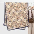 Detailed view of beige paisley print scarf fabric with orange and navy blue patterns - Navy Blue