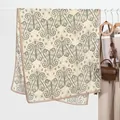 Elegant beige paisley print scarf for women styled with fashion accessories on a rack - Green