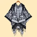 Close-up of black and white paisley jacquard knit shawl with decorative fringe detail - Black & White
