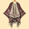 Detailed knit texture of a brown and beige jacquard shawl with decorative black fringe - Coffee