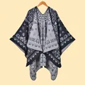 Detailed view of the vintage paisley jacquard pattern and soft knit texture of the shawl - Paisley Vine Black