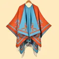 Knitted shawl wrap with orange and blue abstract jacquard pattern and fringe trim - Orange