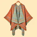 Detail of vintage paisley pattern on a knitted warm travel shawl with orange and blue tones - Paisley Vine Orange