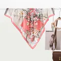 Floral print silk scarf for women in coral pink and beige draped over a hanger - 70x70cm / Color Block Bouquet Pink Gray