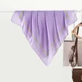 Elegant purple polka dot silk scarf with green borders hanging on a minimal display - Purple Polka Dot