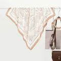 Elegant paisley print silk-like square scarf in white and brown hung with a leather bag - Khaki Paisley Border / Khaki