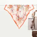 Detail of pink silk scarf with floral tulips hanging next to a leather handbag - Pink Floral Border