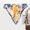Detail of silk scarf with ink lotus floral print draped on white bar for styling - 70x70cm / National Peony
