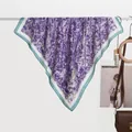 Detail of silk scarf with purple lavender print and white border hung on a display rod - 70x70cm / Lavender