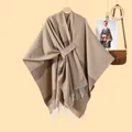 Detail of knit shawl with brown stripes, white fringe, and front tie strap closure - Lace-up Tassel Style / Striped Khaki