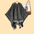 Detailed close-up of a leopard print shawl with white tassel fringe on a wooden hanger - 130x150cm / Leopard Print Black