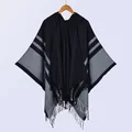 Ethnic style hooded striped poncho for women featuring black knit fabric and tassel details - Black
