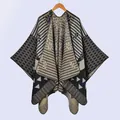 Detail of knit shawl featuring geometric floral patterns and jacquard texture - Black Camel