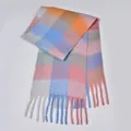Close-up of fluffy rainbow plaid scarf with colorful fringe and soft bouclé yarn texture - Blue & Pink