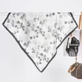 Detailed view of silk-like neck scarf with ginkgo leaf patterns on beige fabric - Watercolor Daisy Black / 70x70cm