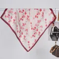 Detail of floral silk scarf with daisy print and deep red borders hanging on a white bar - Watercolor Daisy Pink / 70x70cm