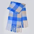 Close-up of fluffy rainbow plaid scarf featuring blue white khaki patterns and fringe detail - Blue Beige Block