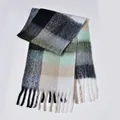 Close-up of rainbow plaid scarf showing fluffy boucle yarn texture and long fringe details - Black Green Contrast