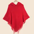 Detail of red hooded knit poncho with long tassel hem and soft textured crochet pattern - Hooded Tassel Knit Poncho / Red