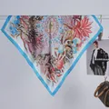 Close-up of sky blue border silk-like square scarf with elegant floral and berry patterns - 70x70cm / Blue