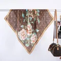 Detailed macro view of vintage floral silk scarf with elegant satin borders - 70x70 / Coffee