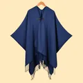Navy blue shawl cloak with leather buckle and fringe hem detail on a wooden hanger - Navy Blue