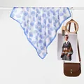Elegant silk scarf with blue ocean seashell prints hanging as a fashion accessory - Blue Shell