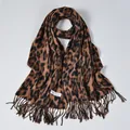Classic leopard print cashmere scarf with fringe edges and brand label on flat lay - 180x70cm / Leopard Print