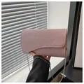 Detail shot of the elegant pink sequined evening bag with a silver chain strap and wavy flap - Pink