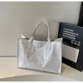 Glossy white tote bag with large capacity and double handles in a modern minimalist style - Off White