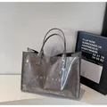 Modern transparent PVC tote bag with dark grey inner pouch and white TOTE BAG text - Gray