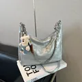 Silver metallic chain tote bag with cute plush bear charm on white magazines - Large / Silver