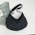 Minimalist black crescent crossbody tote bag with adjustable wide strap and slouchy design - Black